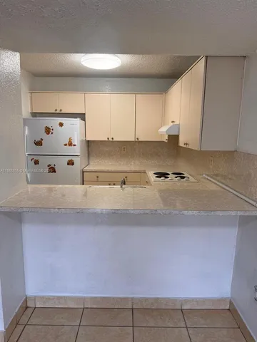 a kitchen with cabinets and white appliances