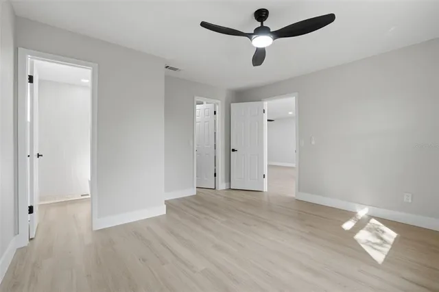 a view of walk in closet with empty racks