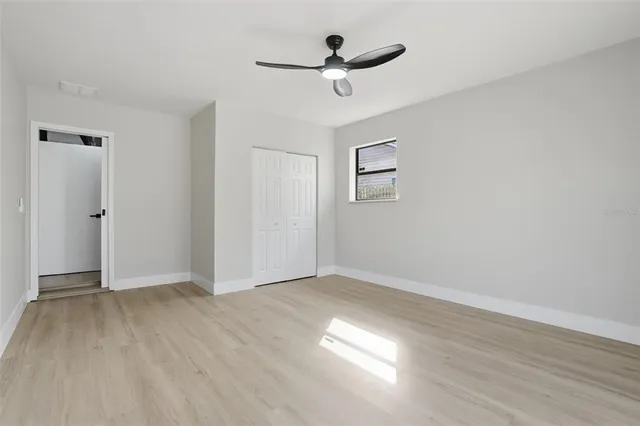 a view of a room with wooden floor