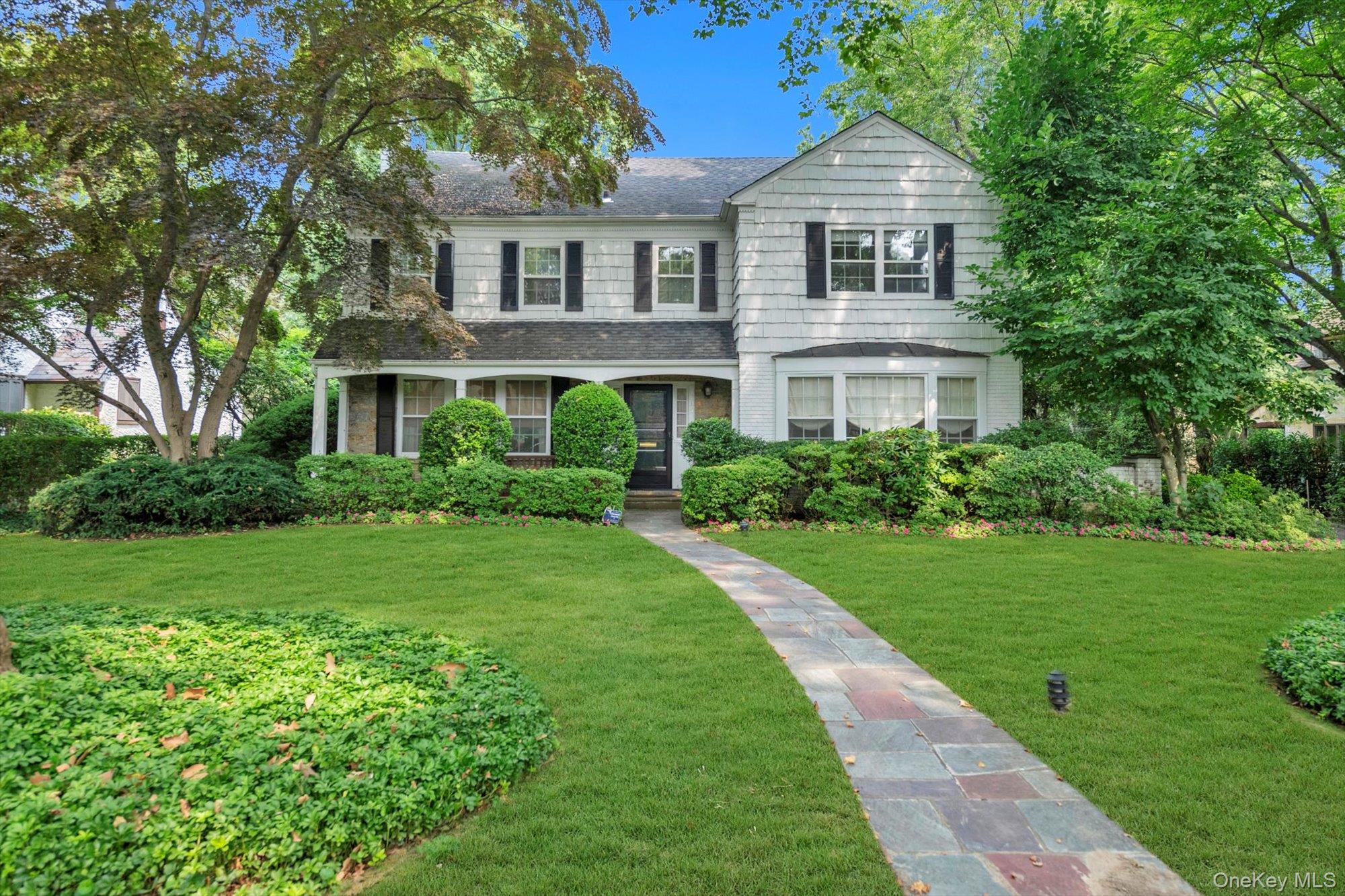 215 Melbourne Road Great Neck, NY 11021 - Photo 1 of 1 a front view of a house with a yard