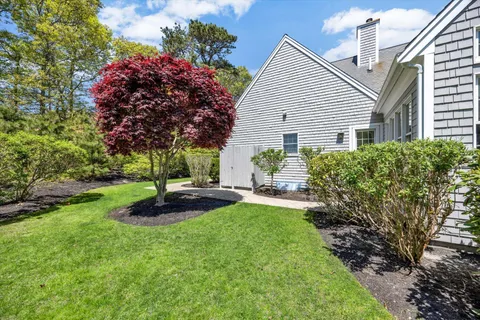 a view of an house with backyard space and garden