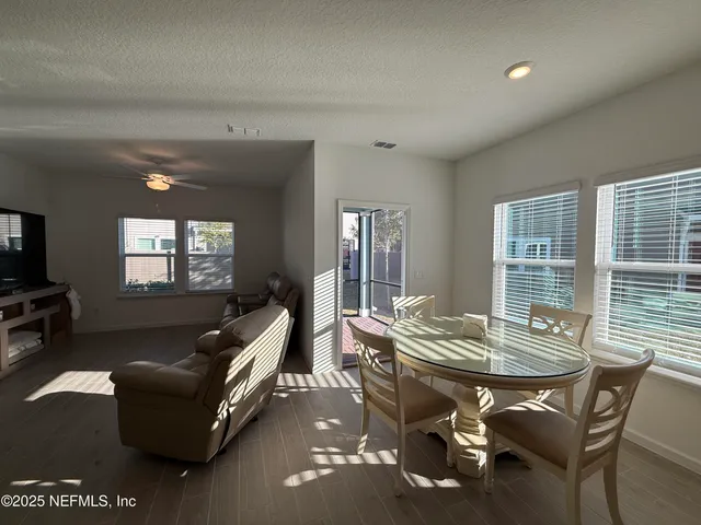 a living room with furniture and large windows