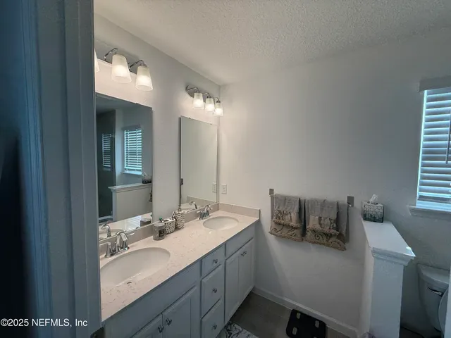 a bathroom with a shower a toilet and a sink