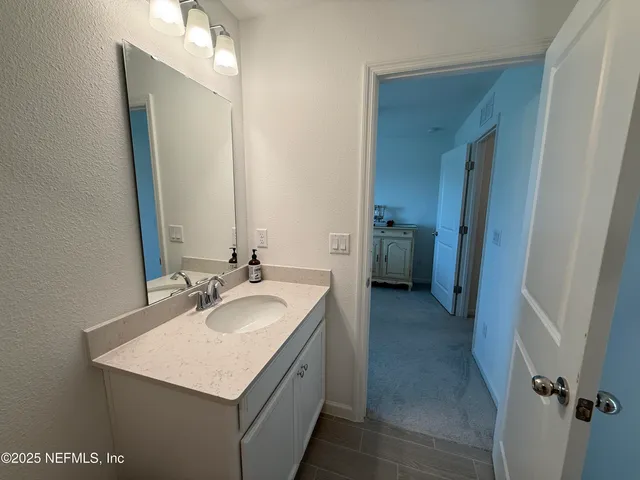 a bedroom with a bed dresser and a window