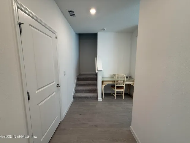 a view of a hallway with chairs
