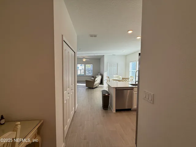 a view of a living room with furniture and a window