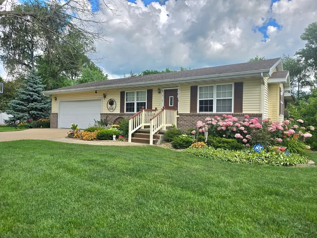 a front view of house with yard and green space