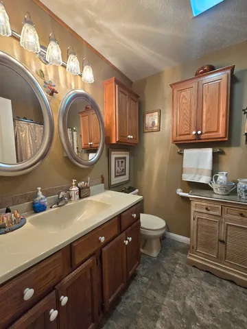 a bedroom with a bed a mirror and a window