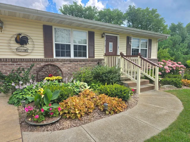a view of a house with a flower garden