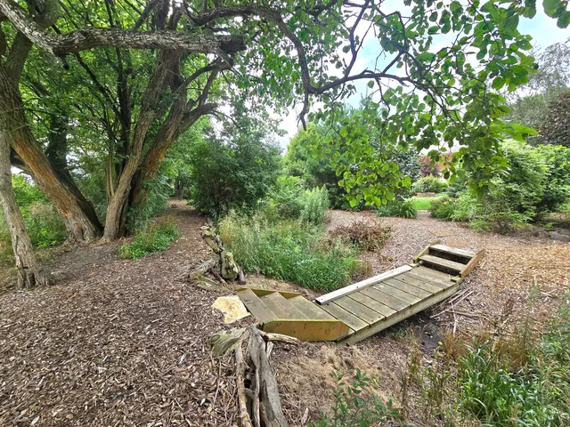 a backyard of a house with lots of green space and garden