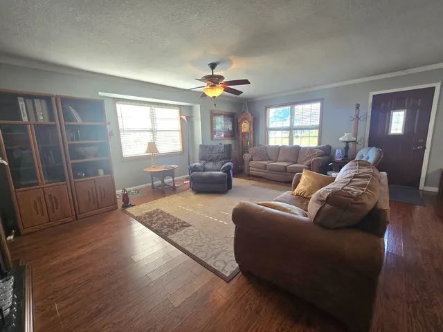 a living room with furniture and wooden floor