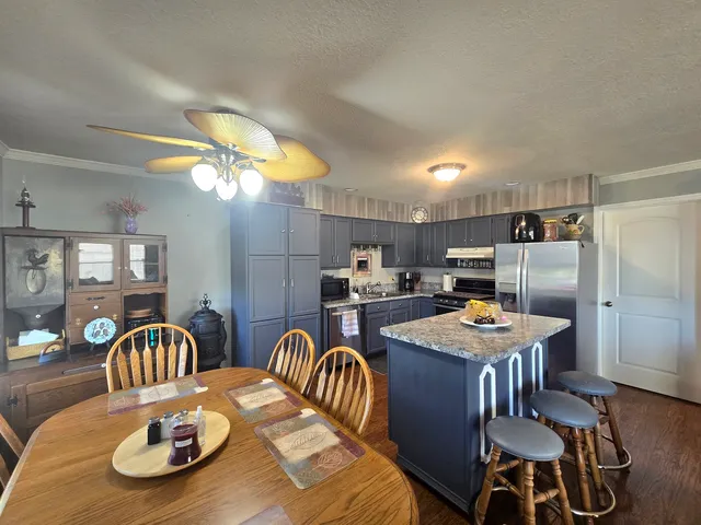 a kitchen with a dining table and chairs