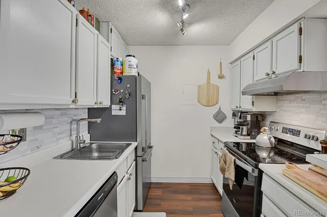 a kitchen with sink and refrigerator