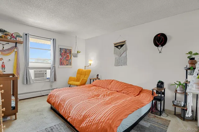 a bedroom with furniture and a flat screen tv