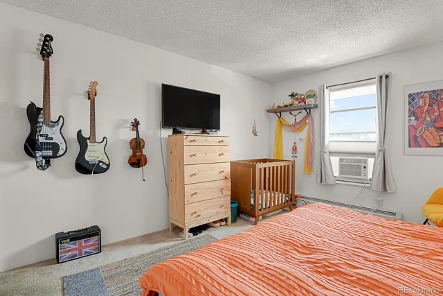 a bedroom with a bed and flat screen tv