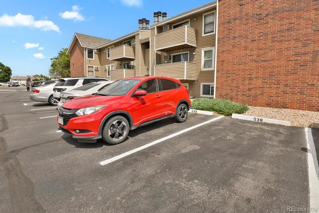 a view of a car parked in front of a building