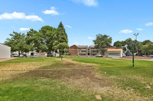 a view of a patio with a table chairs and a backyard