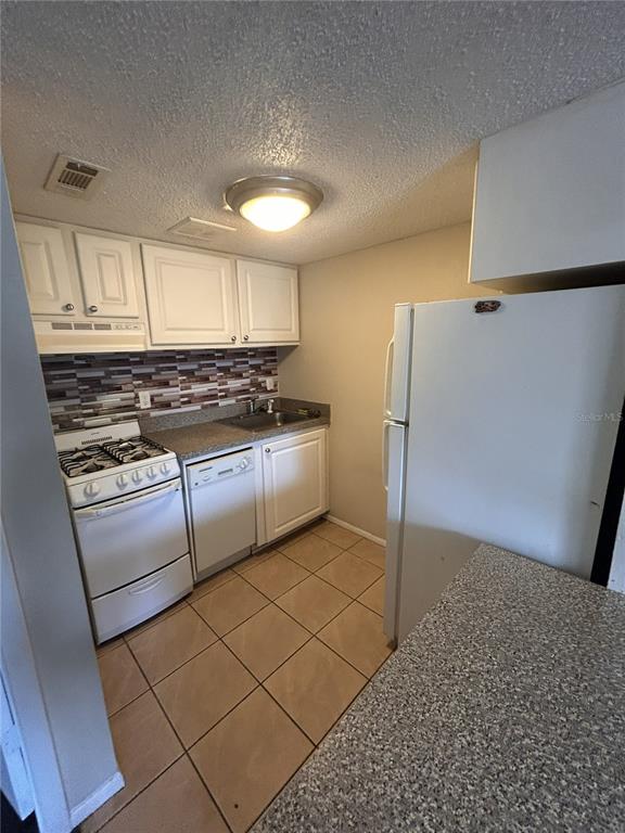 Undisclosed Address Altamonte Springs, FL 32701 - Photo 3 of 11 a kitchen with stainless steel appliances granite countertop a refrigerator and a stove