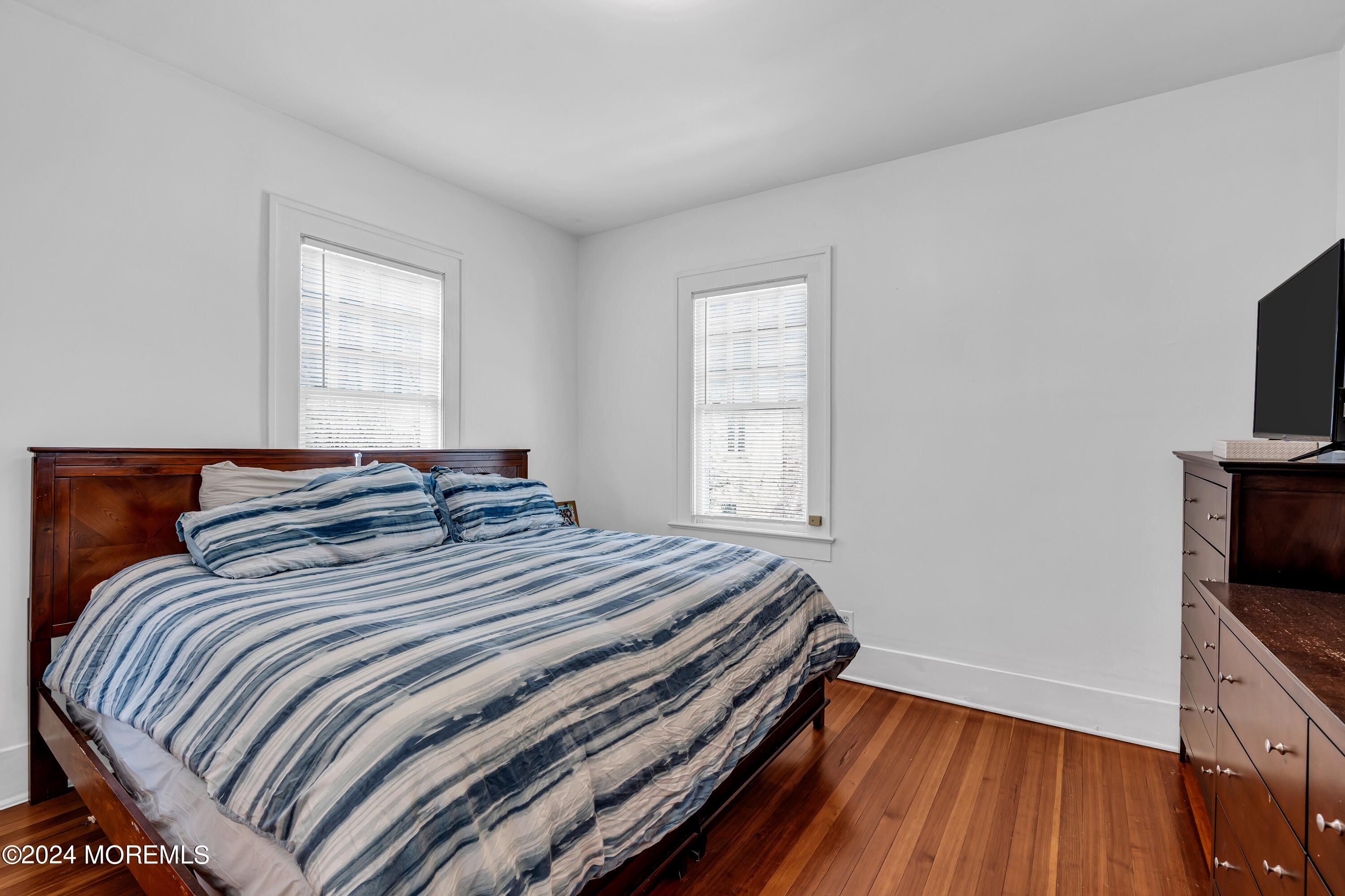 17 Lakeview Road Deal, NJ 07723 - Photo 11 of 30 a bedroom with bed and flat tv screen