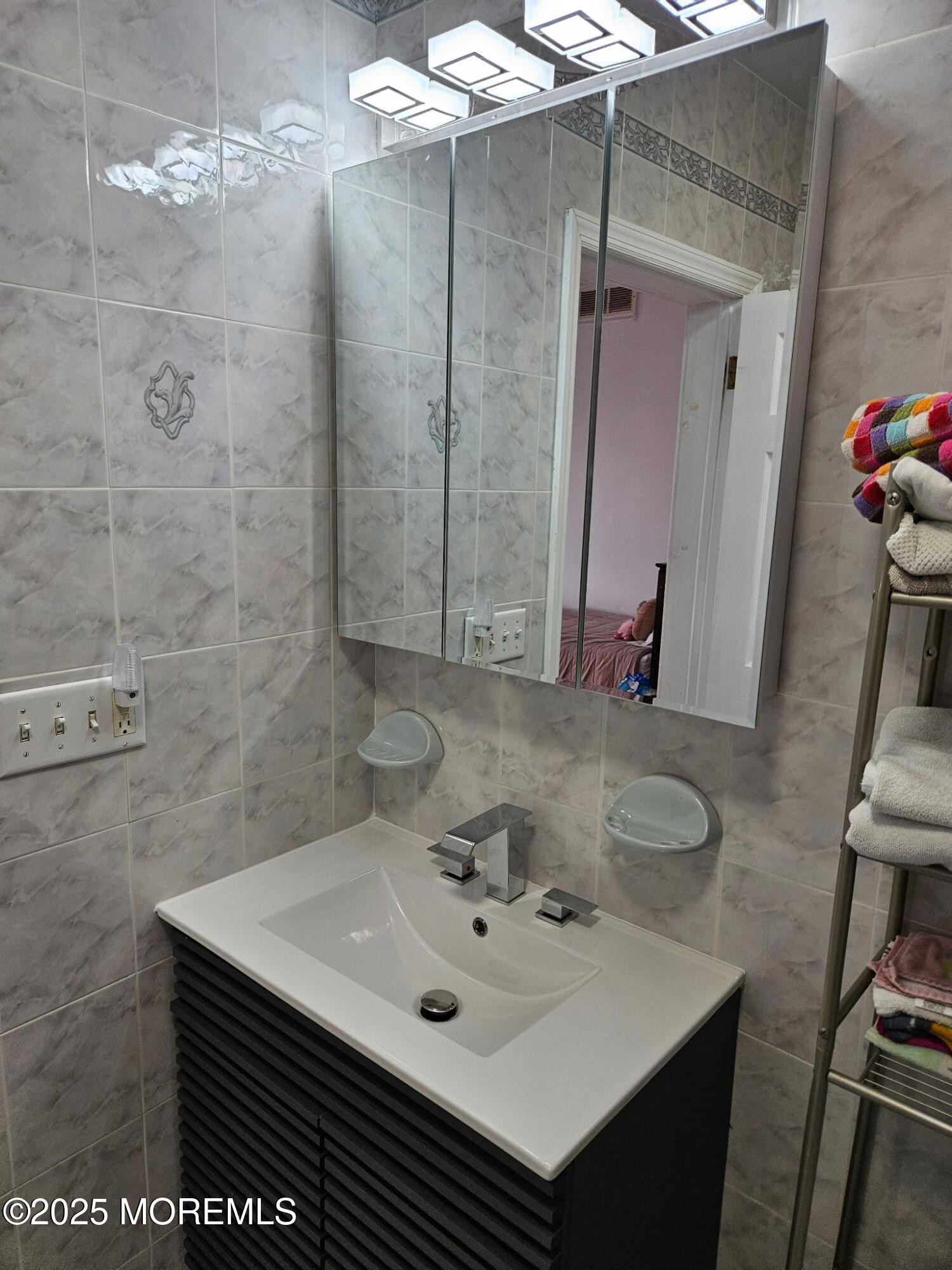 17 Lakeview Road Deal, NJ 07723 - Photo 12 of 30 a bathroom with a sink and a mirror