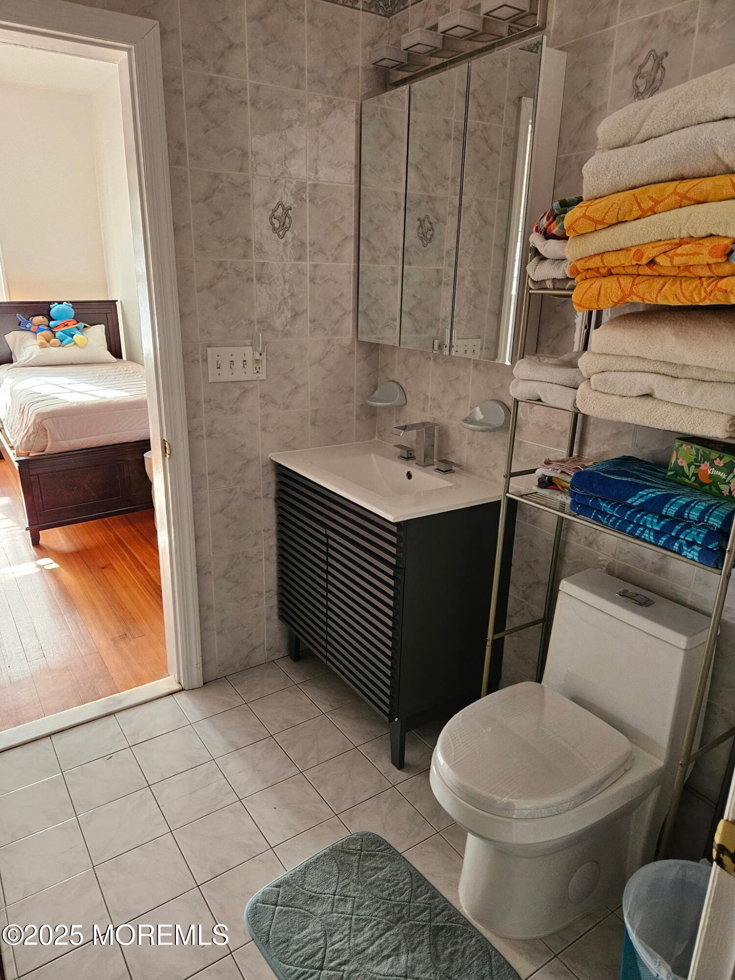 17 Lakeview Road Deal, NJ 07723 - Photo 13 of 30 a bathroom with a granite countertop toilet and a sink