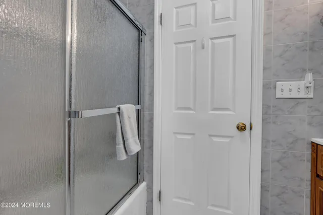 a bathroom with a glass shower door