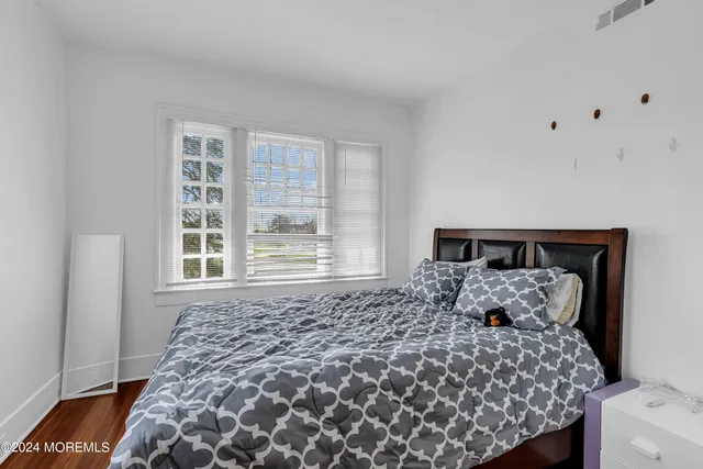 a large bed sitting in a bedroom next to a window