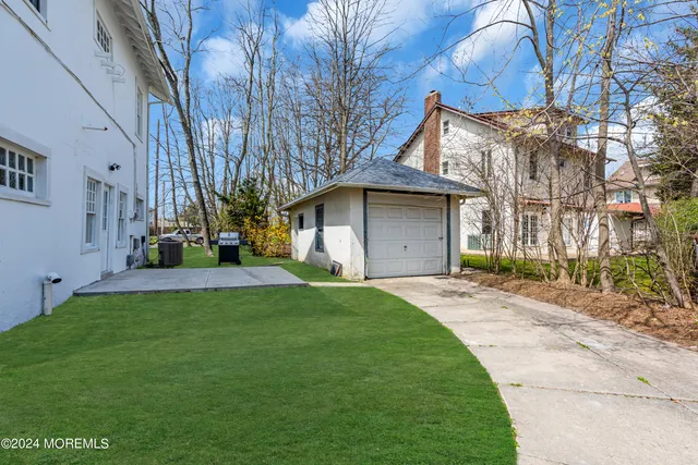 a front view of a house with a garden and yard