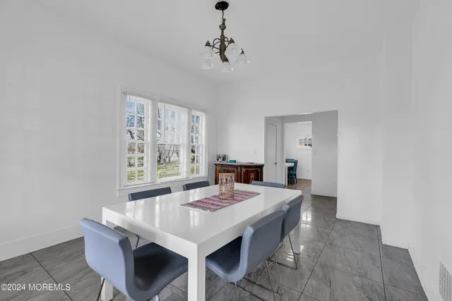 a view of a dining room with furniture and window