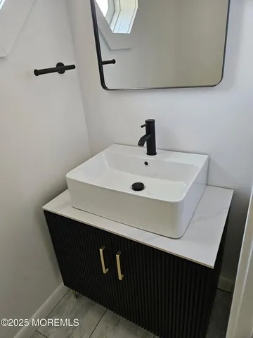 a bathroom with a sink and a mirror