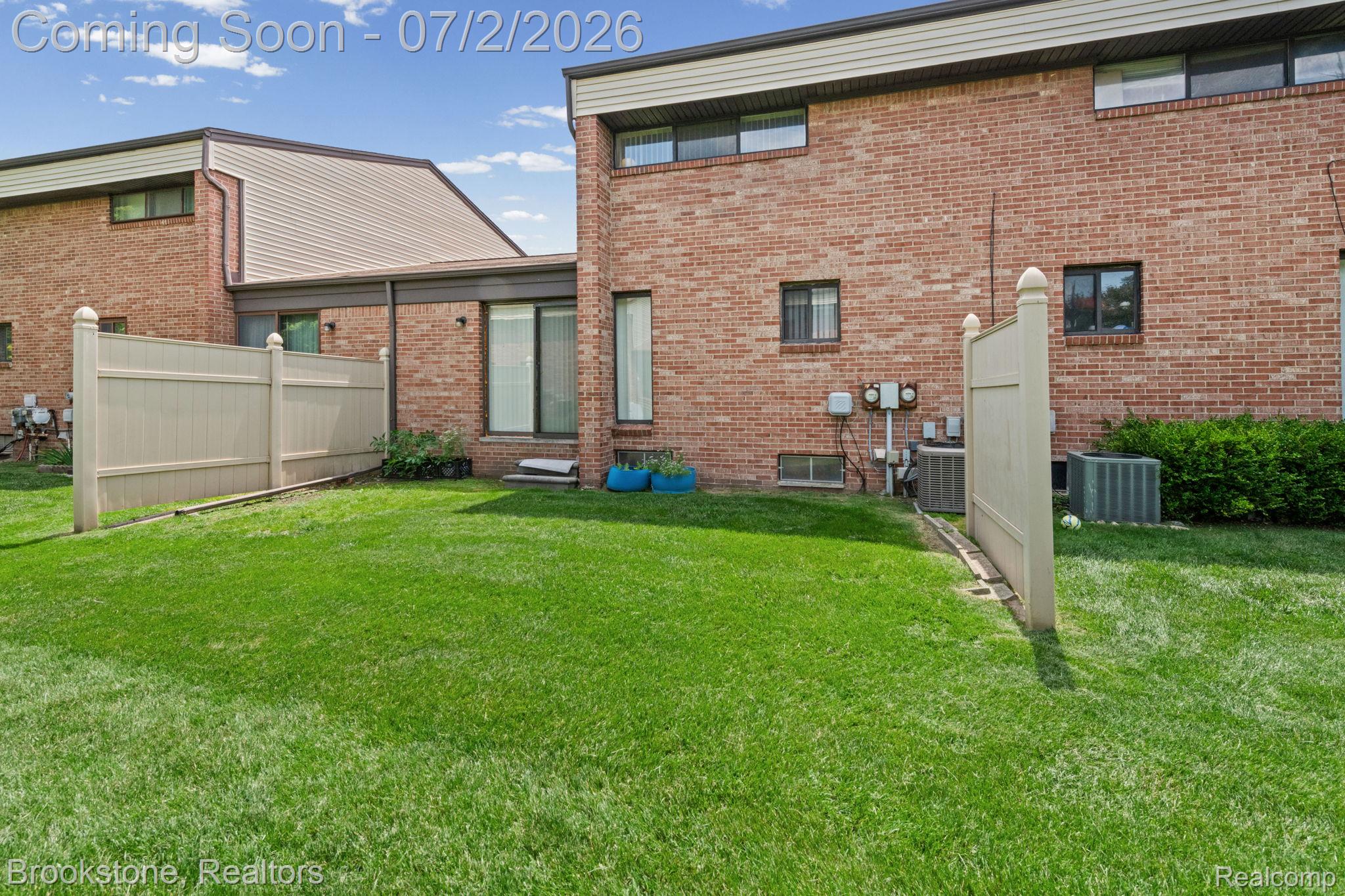 1925 Nicholas Court Warren, MI 48092 - Photo 26 of 26 Expansive green lawn bounded by a beige privacy fence