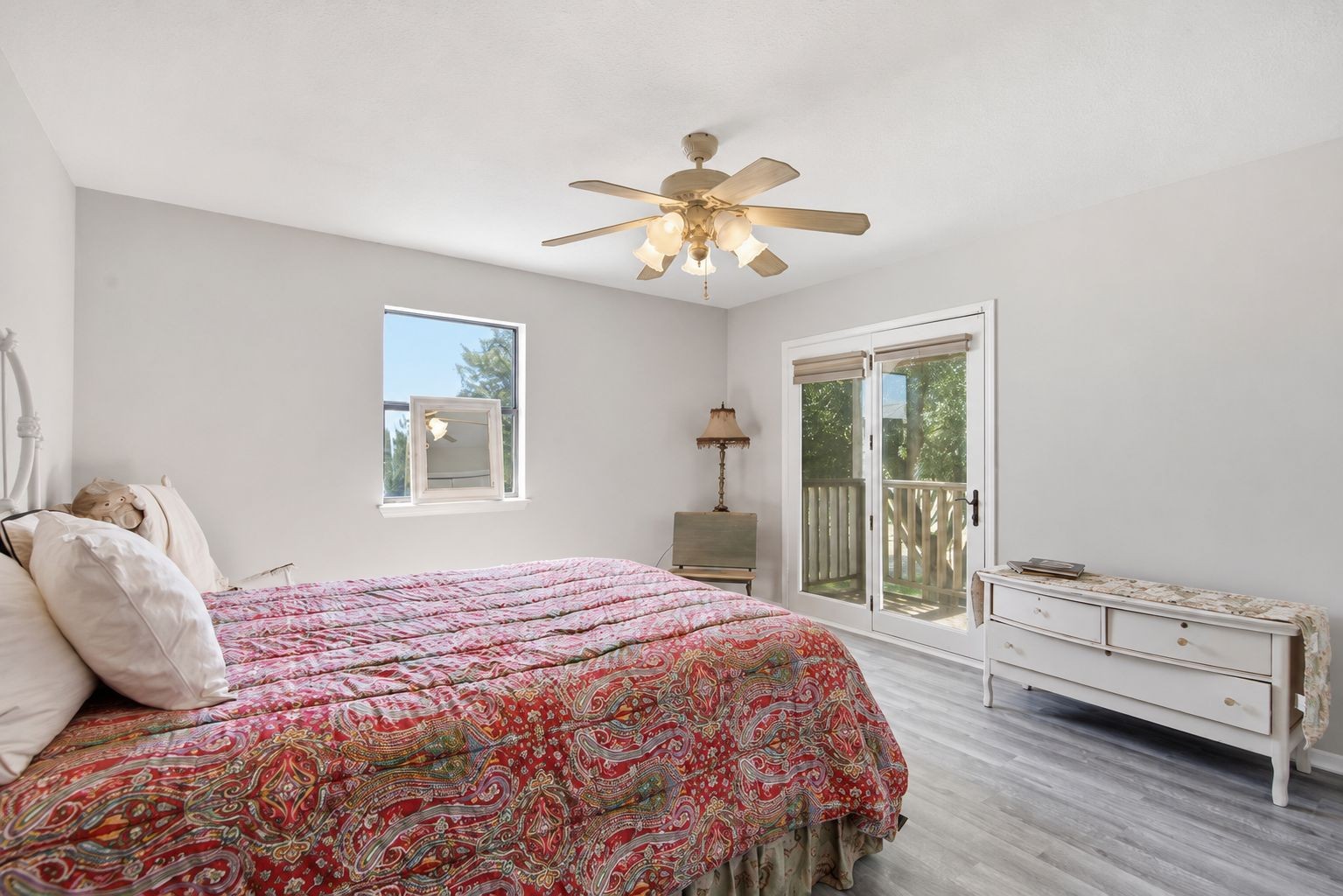 1454 Red Town Road Elgin, TX 78621 - Photo 17 of 40 A restful bedroom offers direct outdoor access and durable wood-look flooring.