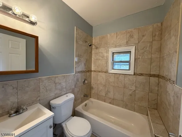 a bathroom with a toilet a sink and bathtub