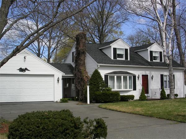 61 Haverhill Road Amesbury, MA 01913 - Photo 2 of 16 a front view of a house with a yard and garage