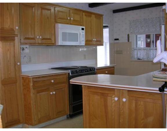 61 Haverhill Road Amesbury, MA 01913 - Photo 3 of 16 a kitchen with a sink and cabinets