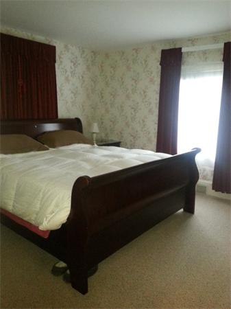 61 Haverhill Road Amesbury, MA 01913 - Photo 8 of 16 a bed sitting in a bedroom next to a window