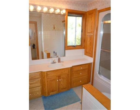 61 Haverhill Road Amesbury, MA 01913 - Photo 9 of 16 a bathroom with a sink and a mirror