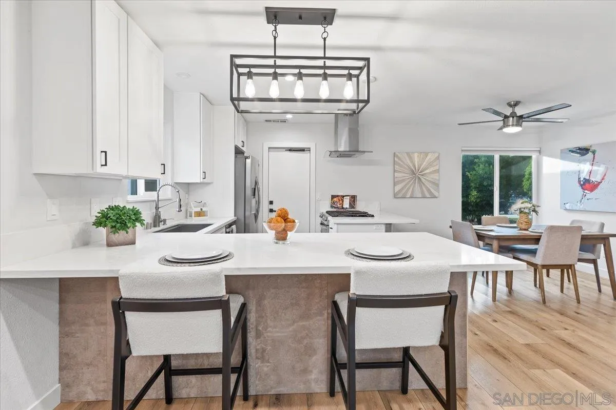 9737 Roe Drive Santee, CA 92071 - Photo 11 of 37 a view of a dining room with furniture and wooden floor