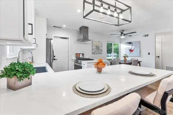 a dining room with stainless steel appliances kitchen island granite countertop furniture and a kitchen view