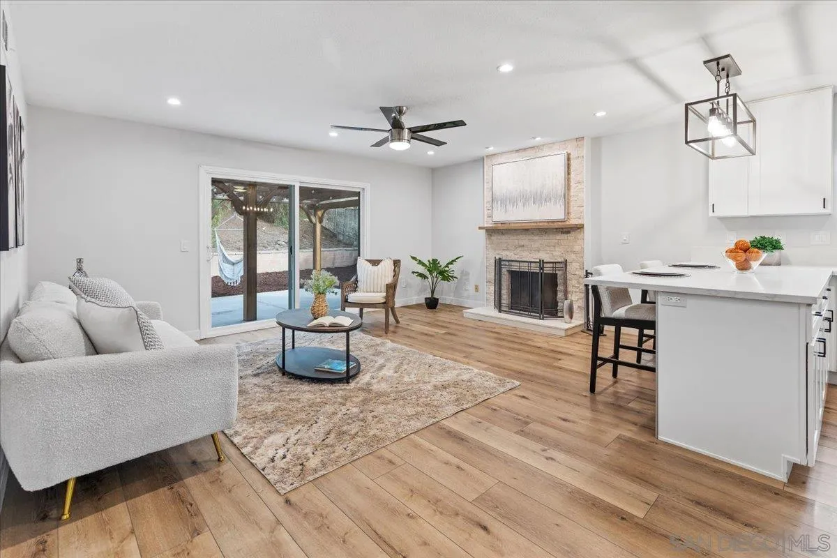 9737 Roe Drive Santee, CA 92071 - Photo 16 of 37 a living room with furniture fireplace and dining table