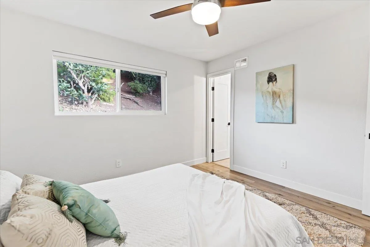 9737 Roe Drive Santee, CA 92071 - Photo 19 of 37 a bedroom with a bed and a painting on the wall