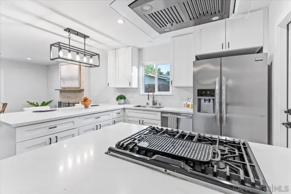 a kitchen with a refrigerator a sink and cabinets