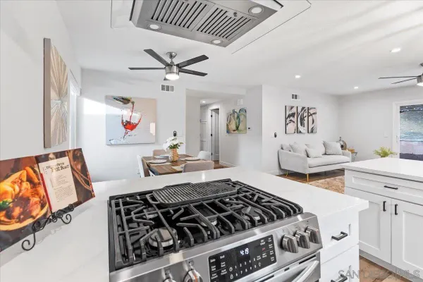 a kitchen with stainless steel appliances granite countertop a stove and a sink