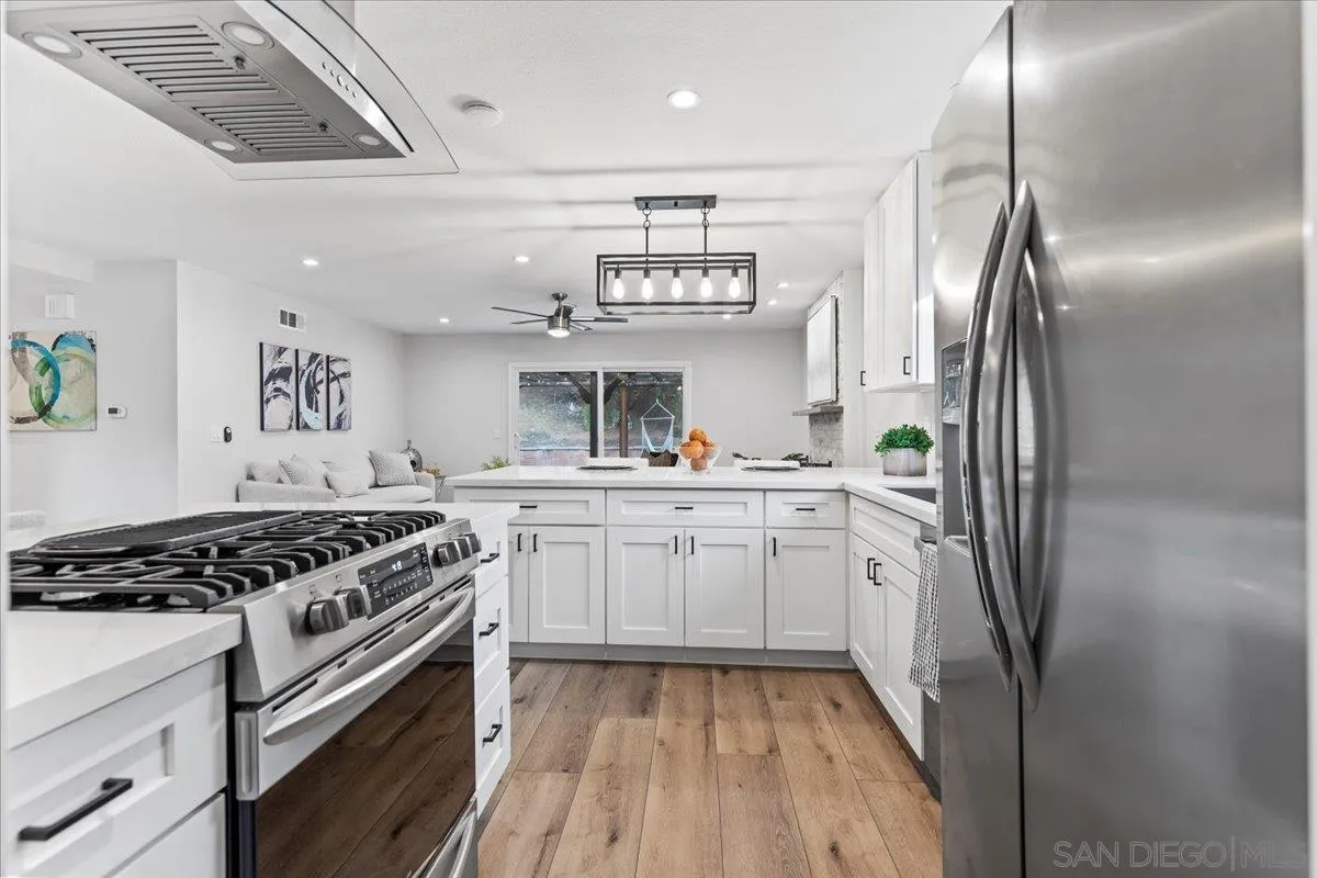 9737 Roe Drive Santee, CA 92071 - Photo 9 of 37 a kitchen with stainless steel appliances granite countertop a stove a refrigerator and a sink
