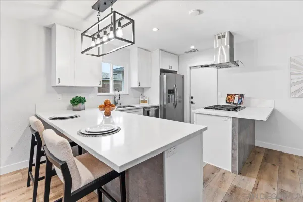 a kitchen with a dining table and chairs