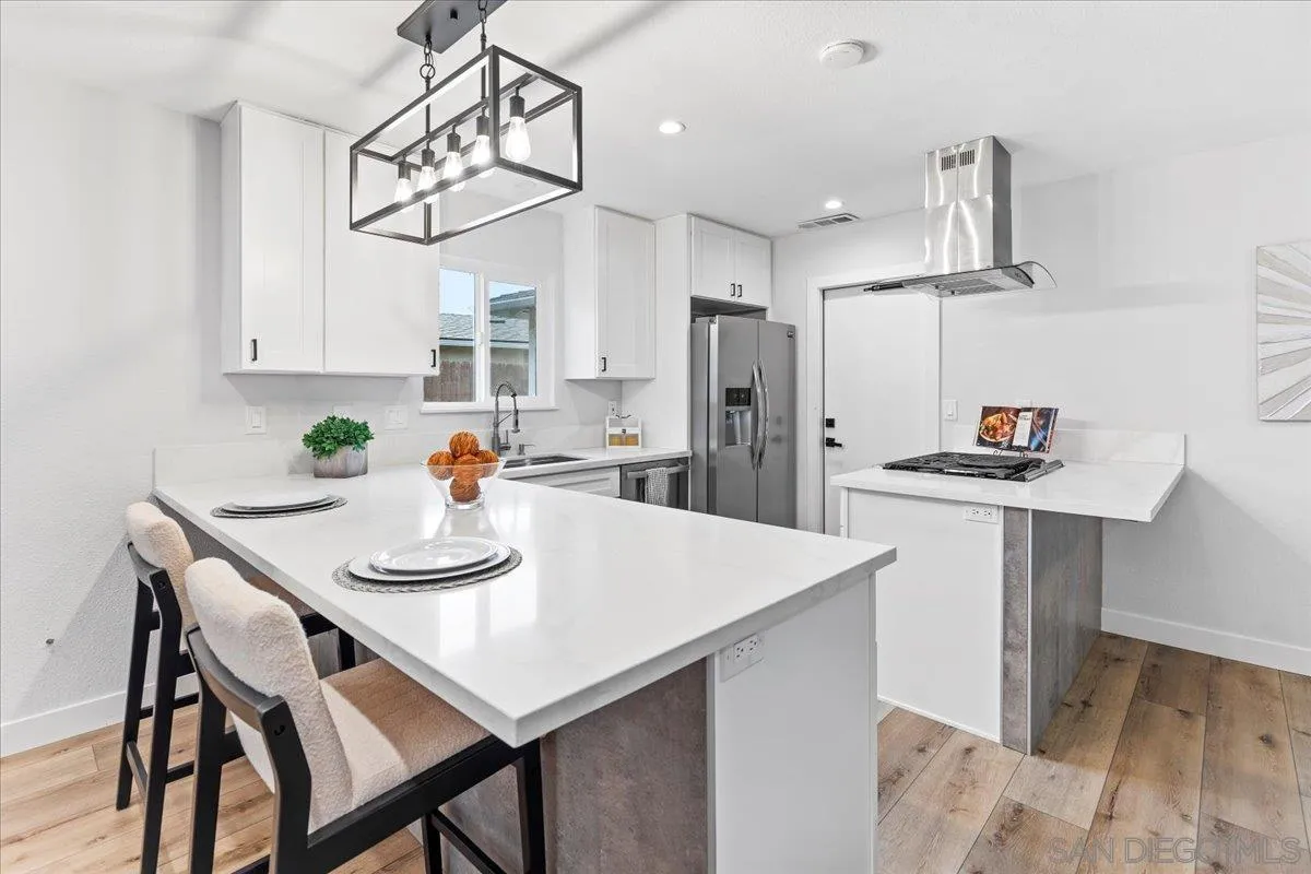 9737 Roe Drive Santee, CA 92071 - Photo 10 of 37 a kitchen with a dining table and chairs