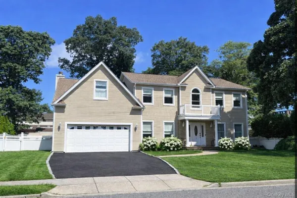 a view of house with a yard and potted plants