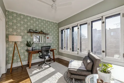 a living room with furniture and a floor to ceiling window