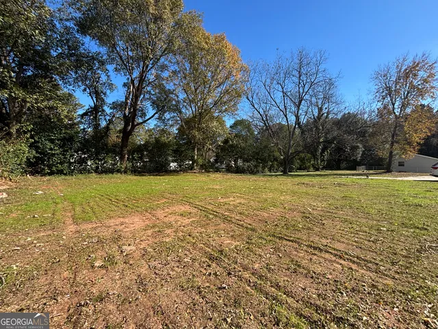 a view of outdoor space with swimming pool and green space