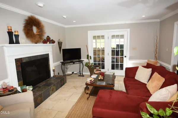a bedroom with a bed a dresser and potted plants